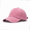 A solid pink washed cotton snapback cap shown from the side.