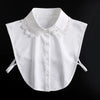 White blouse with a detachable lace false collar and tie-back details.
