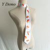 White long neck tie with an orange goldfish print displayed on a mannequin.