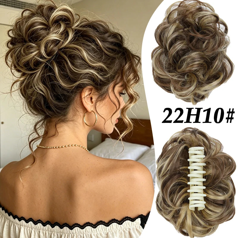 A woman shows off a voluminous curly messy bun hairstyle with blonde and brown highlights.