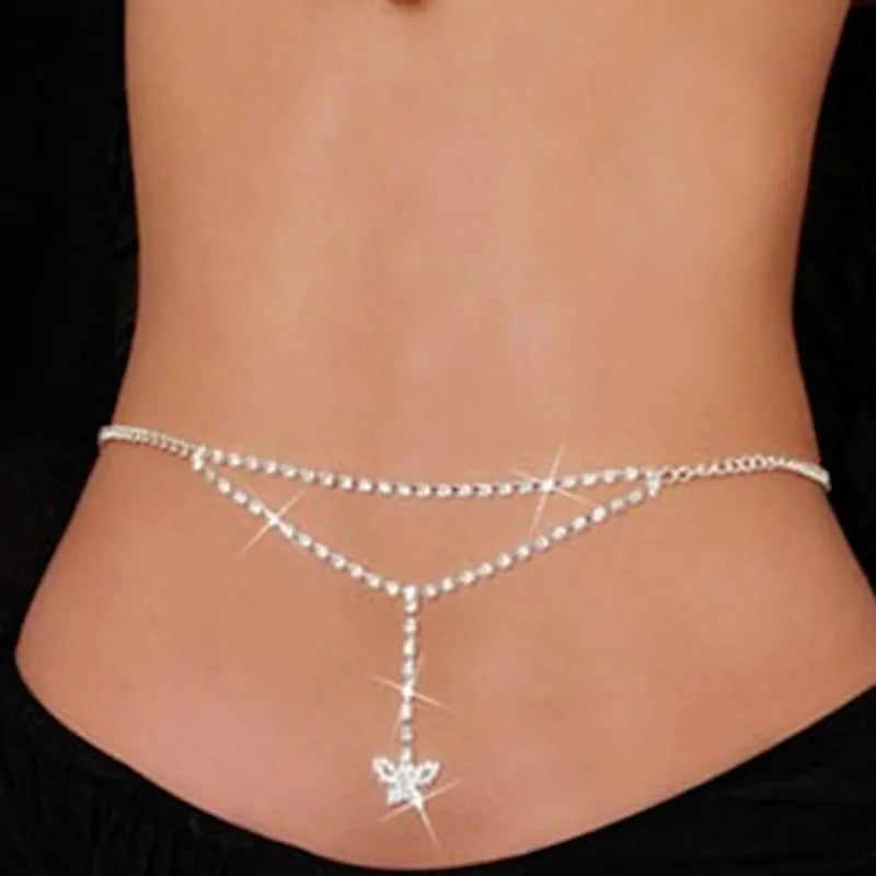 A close-up of a woman's midsection showing a sparkling crystal diamond waist belt worn around the abdomen.