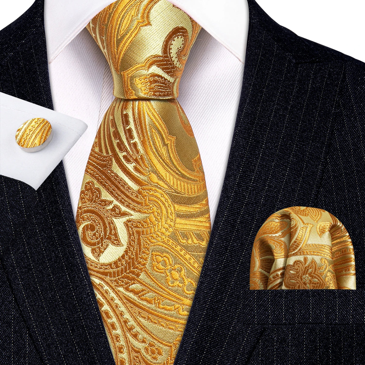 A close-up of a men's silk jacquard tie in gold and brown paisley pattern worn with a dark suit jacket.