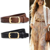 A woman models a beige floral dress and white lace jacket paired with a brown leather belt and gold buckle.