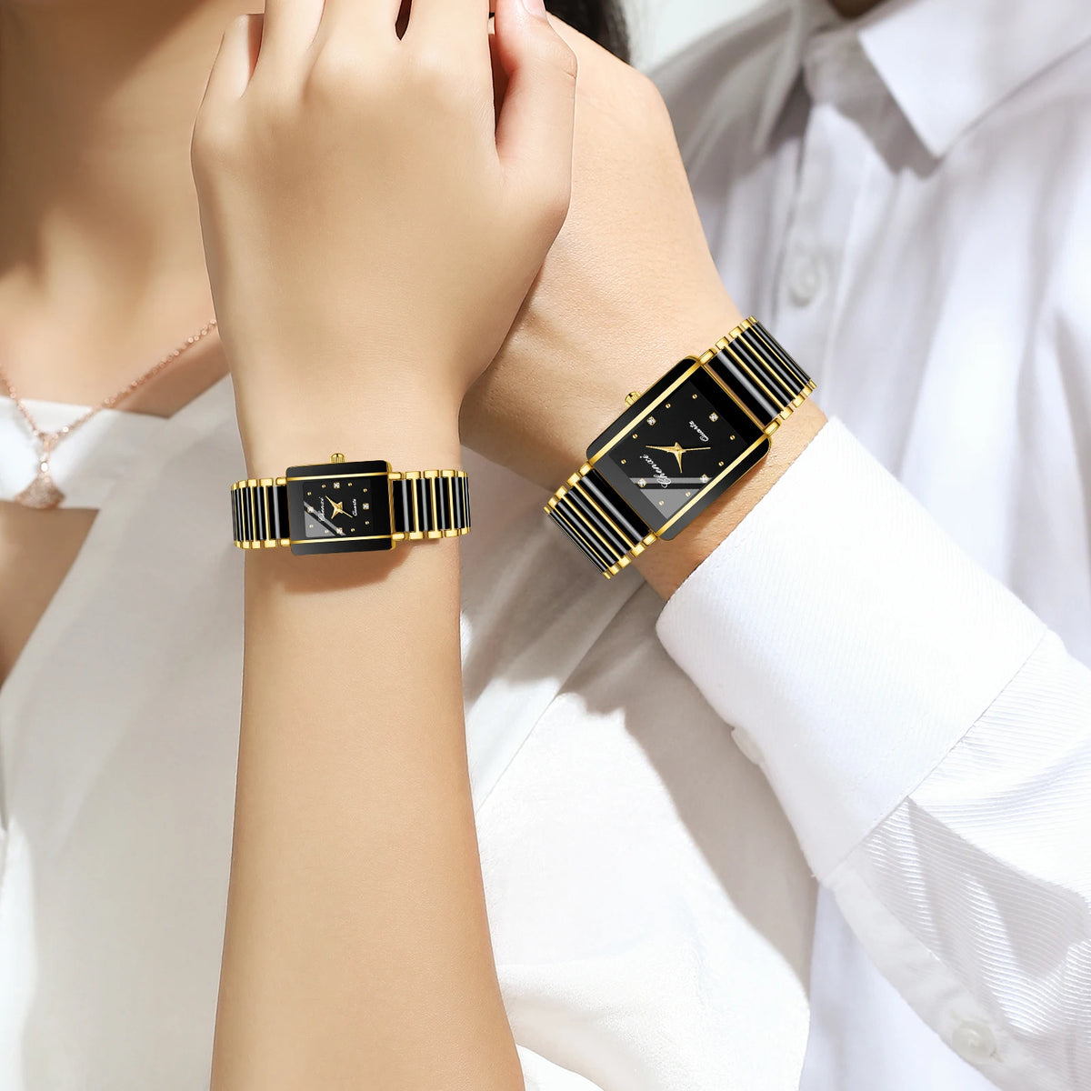 A close-up of two luxury quartz couple watches on wrists, featuring black and gold accents.