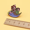 A pair of retro cartoon enamel lapel pins featuring cute, stylized animal characters on a light yellow background.