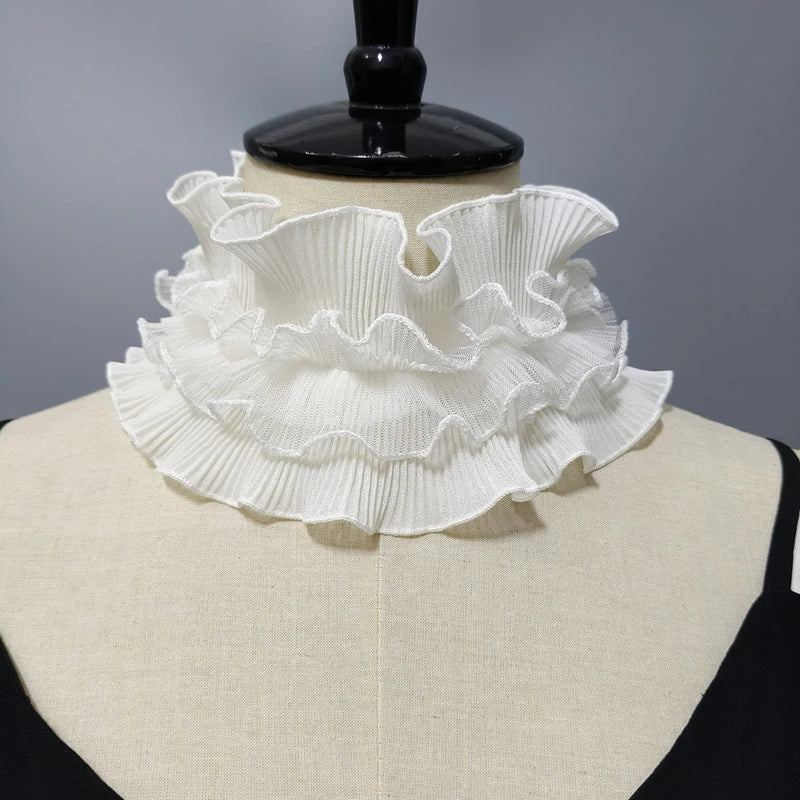White pleated ruffle stand collar sweater displayed on a black mannequin.