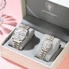 A silver-toned watch set with luminous hands and date display is displayed in a light gray box.