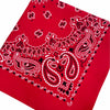 Red fabric featuring white paisley and floral embroidery patterns.