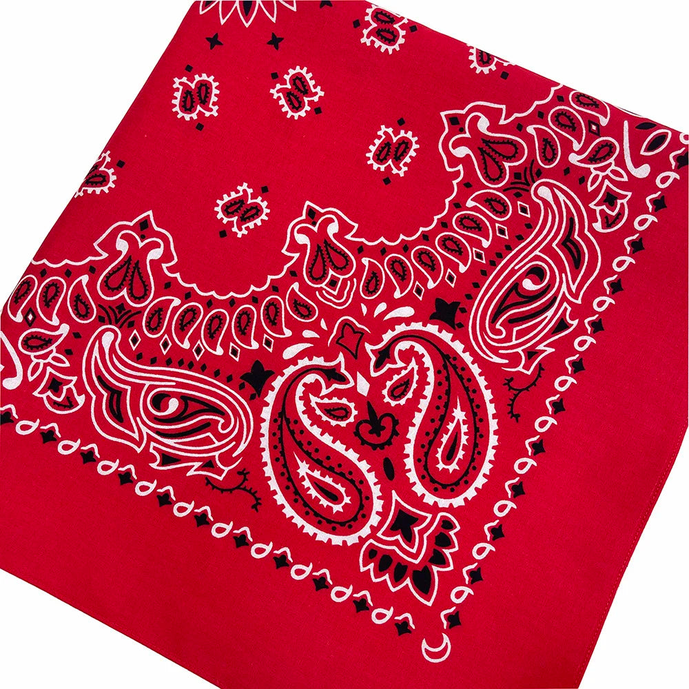 Red fabric featuring white paisley and floral embroidery patterns.