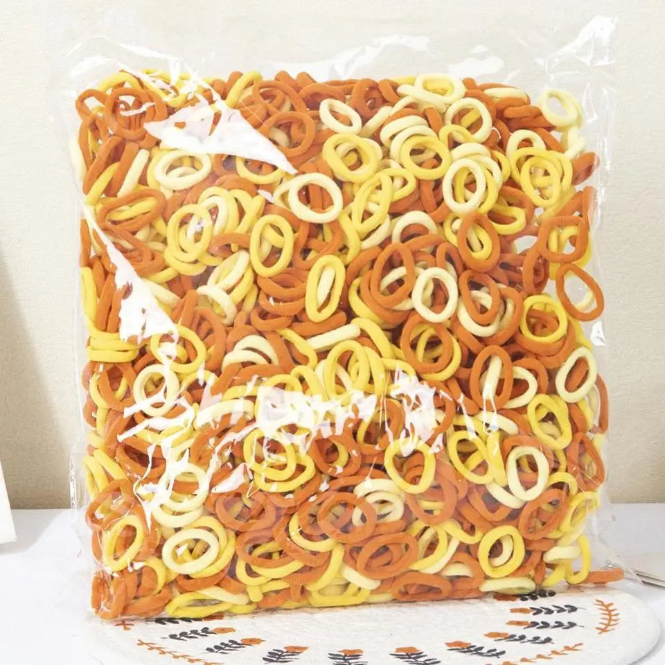 A clear plastic bag filled with colorful nylon elastic hair cords for kids headbands