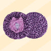 A purple leopard print satin sleep bonnet with a tied bow.