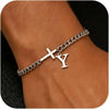 A close-up of a personalized stainless steel cross Cuban chain bracelet worn on a wrist.