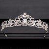 A sparkling silver crystal bridal crown with intricate floral and baroque detailing.