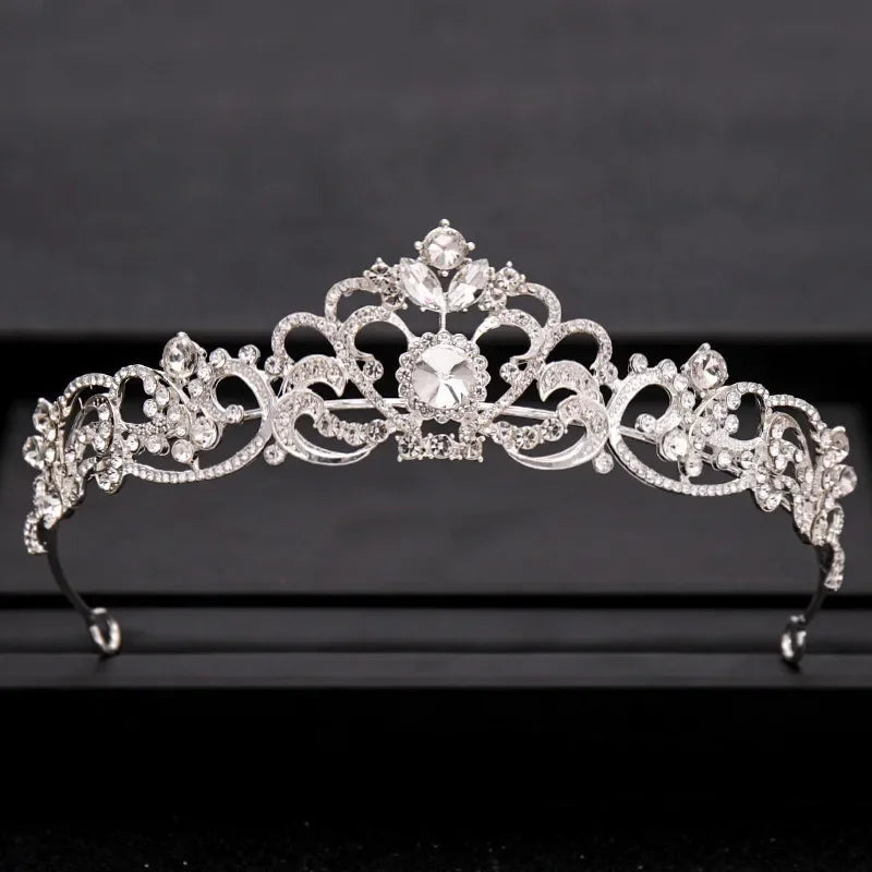 A sparkling silver crystal bridal crown with intricate floral and baroque detailing.