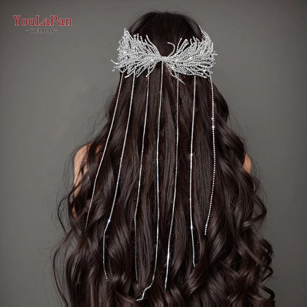 A woman's dark hair is adorned with a bridal headband made of silver tassels and drill chains.