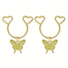A pair of gold heart dangle non-piercing nipple rings with cubic zirconia butterfly charms.