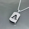 A initial letter stainless steel pendant necklace hanging against a gray background