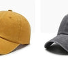 A pair of casual baseball caps, one in mustard yellow and one in dark gray.