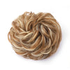 A voluminous, messy bun hairstyle made from light brown and blonde hair.