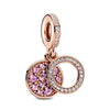Rose gold cherry blossom charm pendant featuring a round pendant and a circular hoop design