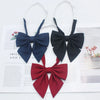 A set of solid cotton bow ties in navy blue and black for dress and uniform use.