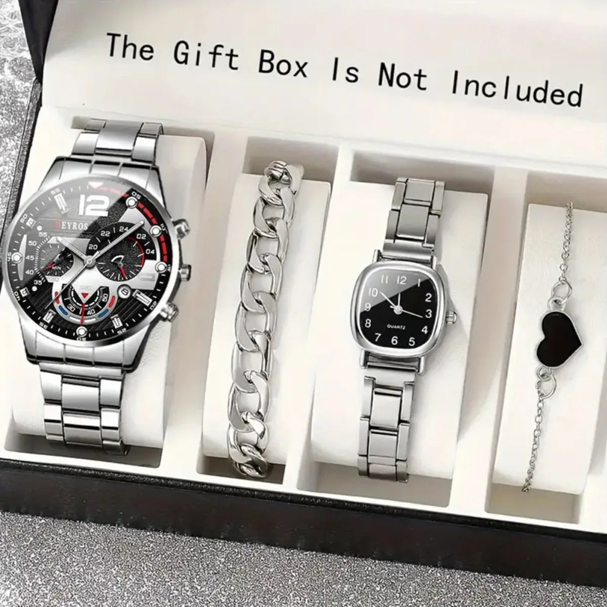 A gift box display showing a silver chronograph watch, a silver chain, and a silver wristwatch inside.