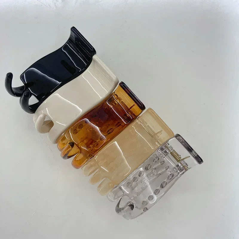 Transparent acrylic hair claw in various shades of beige and amber for ponytail styling