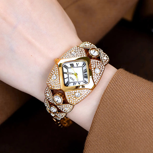 A close-up of a luxury diamond inlaid quartz wristwatch worn on a wrist, featuring a gold casing and diamond-encrusted bezel.