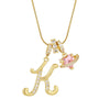 Gold letter K pendant necklace with pink gemstone accent