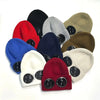 A collection of various knit windproof hats in colors including black, red, blue, gray, and olive green.