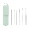 Un juego de herramientas para quitar cerumen de acero inoxidable con una funda protectora verde claro.