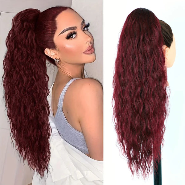 A woman shows off long, deep red hair extensions styled in a high ponytail.