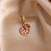 Rose gold pendant featuring a cherry blossom tree design and a diamond-set chain.