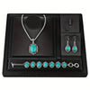 A black jewelry display box featuring a silver necklace, earrings, and bracelet set with turquoise stones.