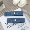 A close-up of a navy blue buckle-free elastic casual belt resting on a white card.