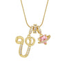 Gold letter pendant necklace featuring a decorative bow and pink gemstone charm