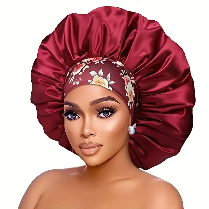 A model wears a deep red satin sleep bonnet with an elastic band and floral embroidery.