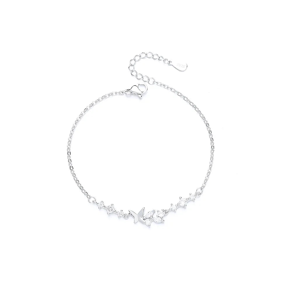 Sterling silver double heart charm bracelet with a delicate chain and small charms