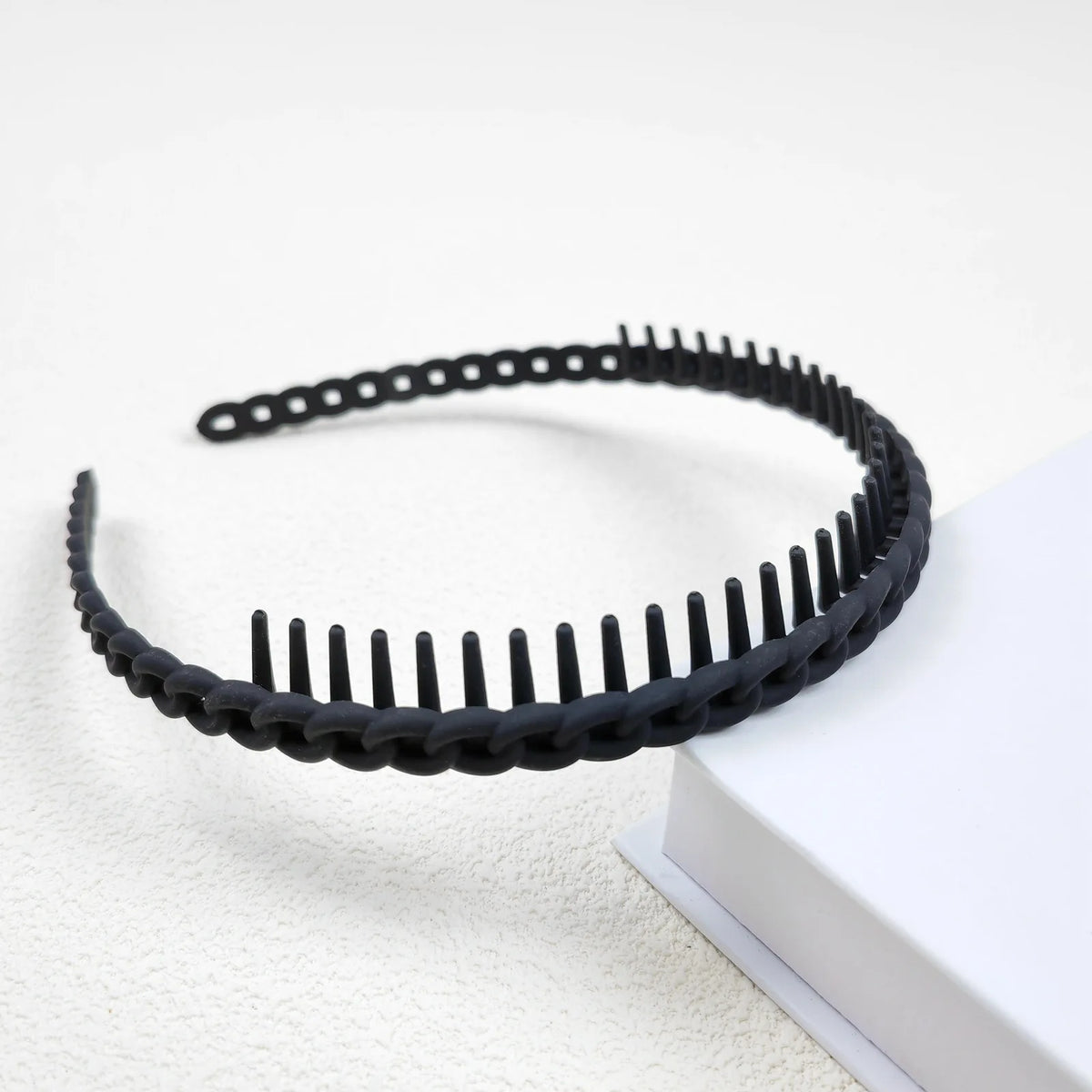 Black frosted toothed anti-slip hair headbands for women displayed on a white surface.