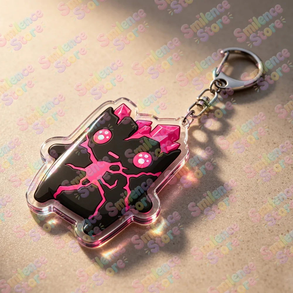 A clear acrylic keychain featuring a black and pink stylized character design on a silver keyring.