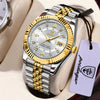 A silver and gold watch with a leather strap is displayed on a light-colored surface.