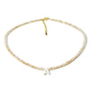 A delicate mother of pearl initial necklace featuring crystal accents and a gold-colored cord.