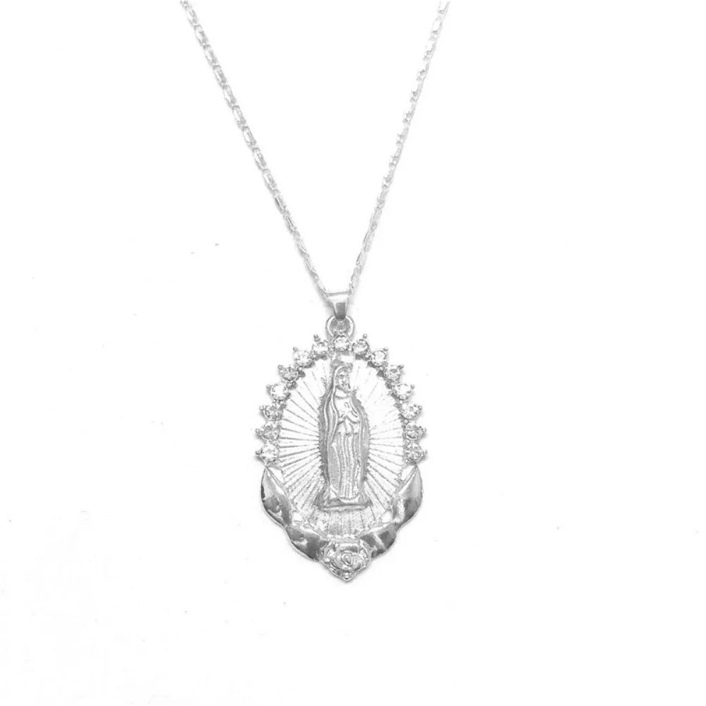 A dainty golden Christian necklace featuring a central figure within a radiant halo design.