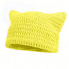 A bright yellow crocheted beanie hat with cat ear shapes.