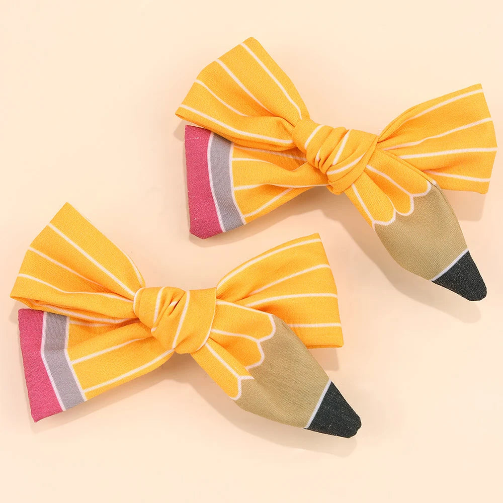 A set of orange and gray striped fabric bow hair clips.