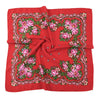 A vibrant red silk scarf featuring an intricate floral print with pink and green roses.