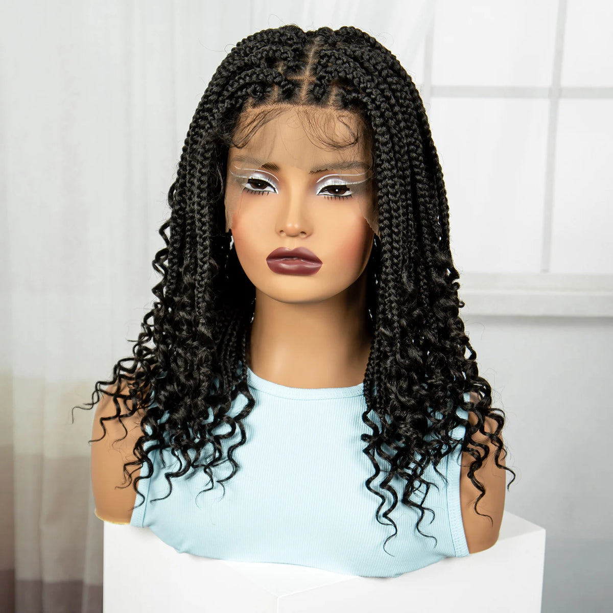A woman modeling a black box braid wig with long, curly hair against a white background.
