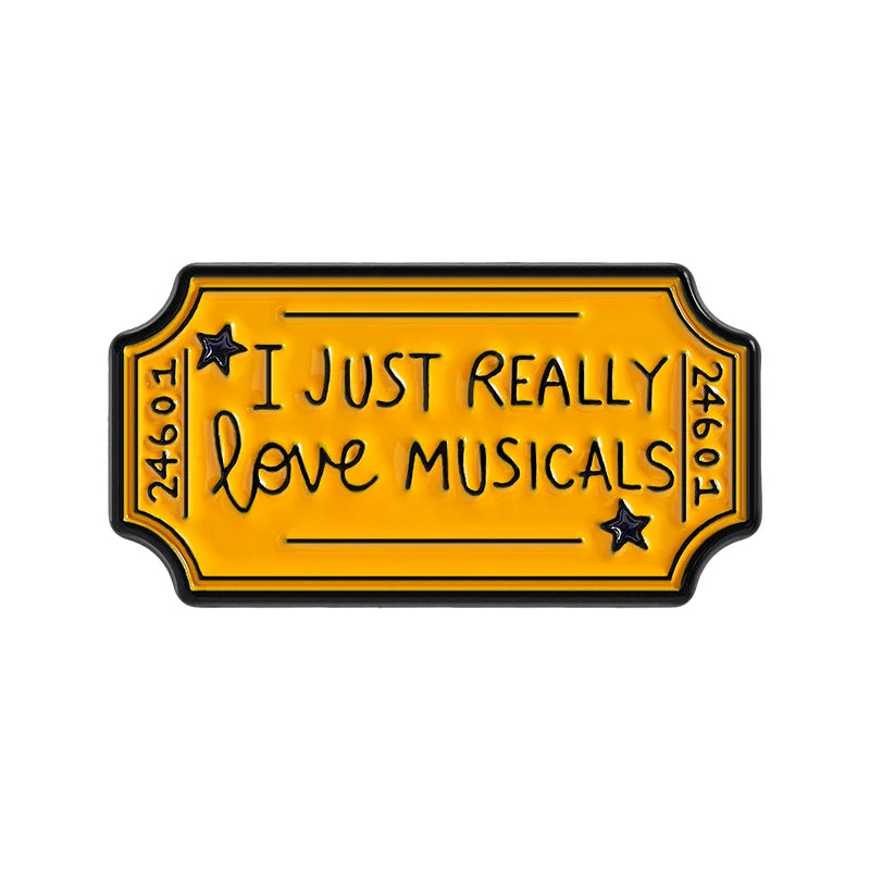 Yellow enamel pin with black border featuring the text I just really love musicals and a star design