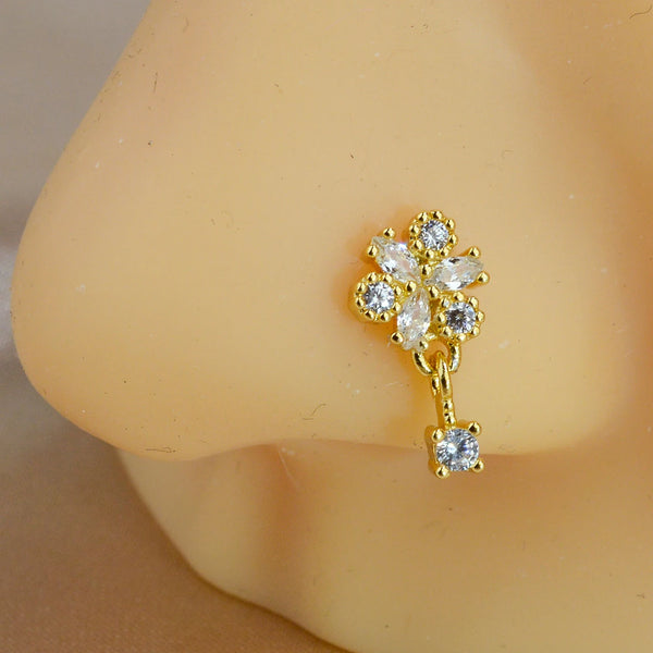 Gold-toned L-shape crystal dangle nose ring with a cluster of small clear stones.