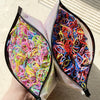 A pair of colorful disposable rubber hair ties, featuring various bright colors like pink, yellow, and blue, are shown in an 